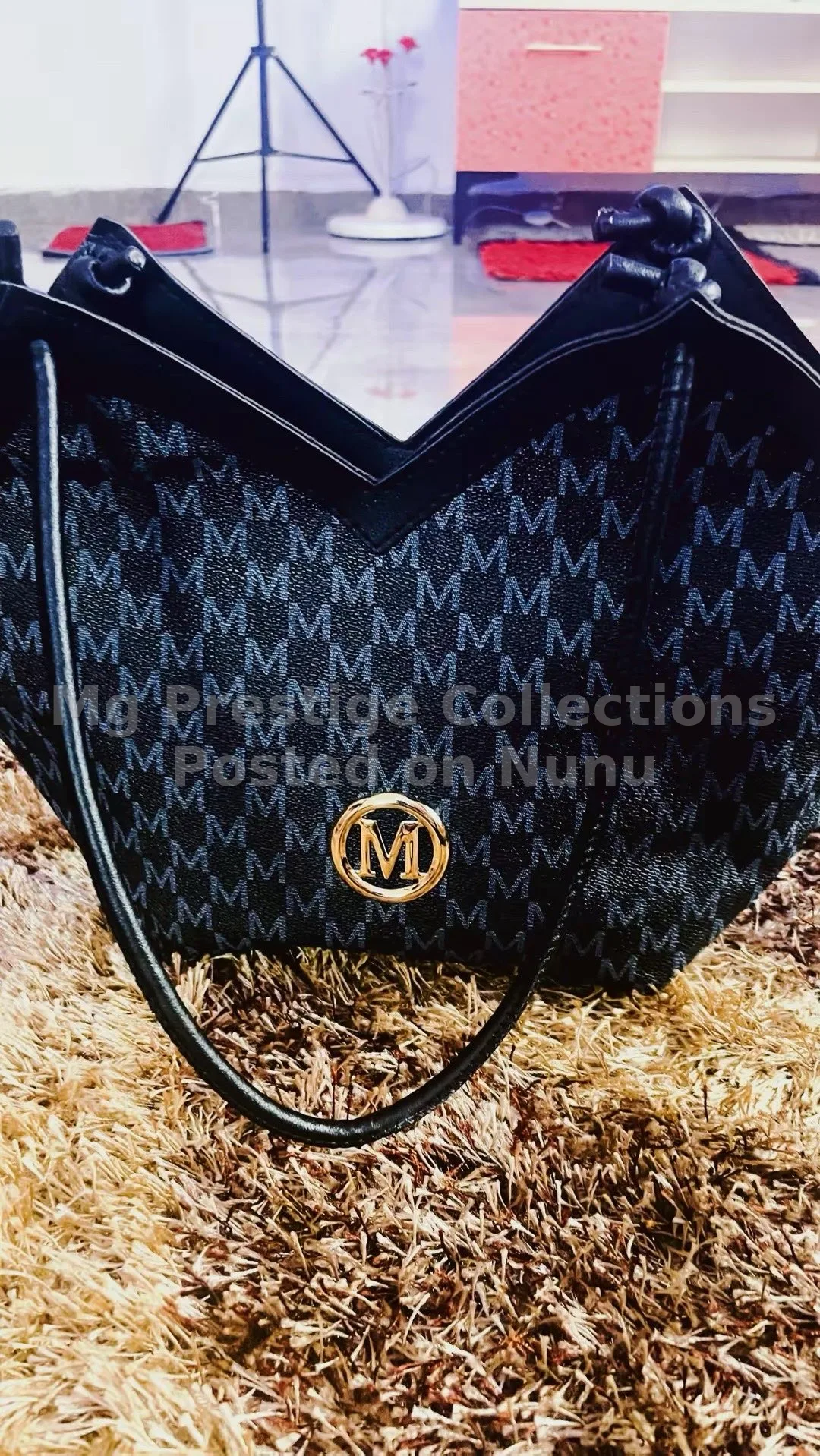 Elegant Black Monogram "M" Pattern Shoulder Bag with Gold Emblem